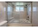 Bathroom featuring tiled tub with glass door and a shower head at 1631 S Lake Ave # 1, Clearwater, FL 33756