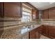 Granite countertops and tiled backsplash are showcased in this well-appointed kitchen view at 1631 S Lake Ave # 1, Clearwater, FL 33756