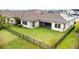 Aerial shot of a large, fenced backyard with well-maintained lawn and screen patio area at 5516 Madrigal Way, Apollo Beach, FL 33572