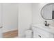 Bathroom featuring a white vanity with a granite countertop, a modern black faucet, and a round black mirror at 5516 Madrigal Way, Apollo Beach, FL 33572