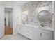 Elegant bathroom with dual vanities, stylish mirrors, designer finishes and fixtures at 5516 Madrigal Way, Apollo Beach, FL 33572