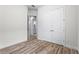 Bedroom featuring a door leading to an ensuite bathroom, a closet, and hardwood floors at 5516 Madrigal Way, Apollo Beach, FL 33572