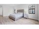 Bright bedroom features a silver, tufted headboard and matching nightstands at 5516 Madrigal Way, Apollo Beach, FL 33572