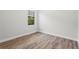 Bright and airy bedroom with hardwood floors, large window, and neutral walls at 5516 Madrigal Way, Apollo Beach, FL 33572