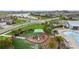 Community amenities featuring a splash pad, playground and lounge chairs surrounded by palm trees and lawns at 5516 Madrigal Way, Apollo Beach, FL 33572