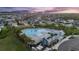 An aerial shot showcasing a community pool, clubhouse, and manicured landscapes at 5516 Madrigal Way, Apollo Beach, FL 33572