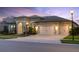 Beautiful home featuring a three-car garage and landscaped front yard at 5516 Madrigal Way, Apollo Beach, FL 33572
