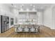 Bright kitchen with a large island, seating for four, stainless steel appliances, and white cabinetry at 5516 Madrigal Way, Apollo Beach, FL 33572
