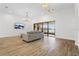 Bright living room with comfortable seating, modern lighting, and sliding glass doors at 5516 Madrigal Way, Apollo Beach, FL 33572