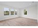 Bright living room with wood-look tile and windows, offering natural light at 5516 Madrigal Way, Apollo Beach, FL 33572