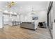 Open-concept living room and kitchen with modern lighting and wood-look tile flooring at 5516 Madrigal Way, Apollo Beach, FL 33572