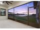 Screened in lanai with views of the lake at sunset at 5516 Madrigal Way, Apollo Beach, FL 33572