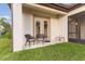 This cozy patio area has two chairs, perfect for enjoying the outdoors at 5516 Madrigal Way, Apollo Beach, FL 33572