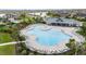 Aerial shot of a community pool with abundant lounge chairs and a playground for community residents at 5516 Madrigal Way, Apollo Beach, FL 33572