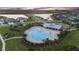 A stunning shot of a community pool and recreation area, surrounded by lush landscaping and walking paths at 5516 Madrigal Way, Apollo Beach, FL 33572