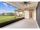 Enclosed porch area with ceiling fan and view of the fenced in backyard at 5516 Madrigal Way, Apollo Beach, FL 33572