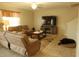 Inviting living room with plush sofas, a large TV, and a cozy rug creating a comfortable space at 14825 Crescent Rock Dr, Wimauma, FL 33598