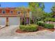 Charming two-story villa with red tile roof, brick driveway and lush landscaping at 2353 Max Ct, New Port Richey, FL 34655