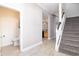 Inviting foyer with staircase, modern flooring, and views of the half bathroom and kitchen at 2353 Max Ct, New Port Richey, FL 34655