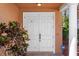 Inviting double front door entry with decorative sidelights and colorful landscaping at 2353 Max Ct, New Port Richey, FL 34655