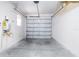 A spacious garage with an automatic door, water heater, and ample room for parking and storage at 2353 Max Ct, New Port Richey, FL 34655