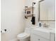 Clean half bathroom featuring a modern vanity, fixtures, and industrial decor at 2353 Max Ct, New Port Richey, FL 34655