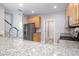 Spacious kitchen features granite countertops and stainless steel appliances and modern faucet at 2353 Max Ct, New Port Richey, FL 34655