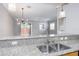 Granite counters feature stainless steel sink and modern faucet in this bright eat-in kitchen at 2353 Max Ct, New Port Richey, FL 34655