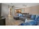 Stylish living room with modern wood floors, ceiling fan and open layout to kitchen at 2353 Max Ct, New Port Richey, FL 34655