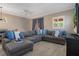 Comfortable living room featuring stylish furniture, ceiling fan and modern wood floors at 2353 Max Ct, New Port Richey, FL 34655