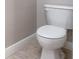 A white toilet is positioned in a clean and bright space with tile flooring and neutral wall at 2353 Max Ct # 28, New Port Richey, FL 34655