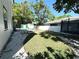 Backyard featuring a lush lawn, privacy fence, and storage shed at 3025 W North A St, Tampa, FL 33609