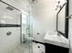 Modern bathroom featuring a glass-enclosed shower, marble-top vanity, and black-and-white tiled flooring at 3025 W North A St, Tampa, FL 33609