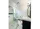 Elegant bathroom featuring a tiled shower, modern vanity with marble countertop, and stylish fixtures at 3025 W North A St, Tampa, FL 33609
