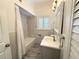 Renovated bathroom boasts marble-look tile, sleek vanity, and shower with new fixtures at 3025 W North A St, Tampa, FL 33609