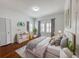 Cozy bedroom with hardwood floors, soft gray accents and ample natural light at 3025 W North A St, Tampa, FL 33609