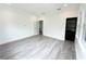 Spacious bedroom with light gray wood-look flooring, ample natural light, and doorway into another room at 3025 W North A St, Tampa, FL 33609