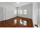 Bright bedroom featuring gleaming hardwood floors, white trim, and plantation shutters at 3025 W North A St, Tampa, FL 33609