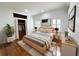 Stylishly staged bedroom features hardwood floors, plantation shutters, and neutral decor at 3025 W North A St, Tampa, FL 33609