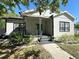 Charming single-story home with well-manicured landscaping, inviting front porch, and classic architectural details at 3025 W North A St, Tampa, FL 33609
