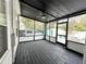 Relaxing screened-in patio with dark wood flooring, ideal for entertaining and enjoying outdoor living at 3025 W North A St, Tampa, FL 33609