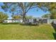 Large backyard featuring a lush lawn, shaded seating area, and perfect for outdoor gatherings at 4335 S Coolidge Ave, Tampa, FL 33611