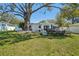 Expansive backyard featuring mature trees, ample lawn space, and a comfortable seating, perfect for enjoying the outdoors at 4335 S Coolidge Ave, Tampa, FL 33611