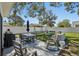 Spacious backyard featuring patio seating, a well-manicured lawn, and a serene outdoor dining experience at 4335 S Coolidge Ave, Tampa, FL 33611