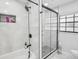 Modern bathroom with a bathtub, glass shower, and sleek black fixtures, offering a spa-like experience at 4335 S Coolidge Ave, Tampa, FL 33611