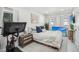 Cozy bedroom featuring a comfortable bed, Peloton, and bright natural light from multiple windows at 4335 S Coolidge Ave, Tampa, FL 33611