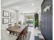 Open dining room with a large wood table and six chairs, with sliding glass doors to the patio at 4335 S Coolidge Ave, Tampa, FL 33611