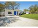 Beautiful home exterior with a bright blue front door, fresh landscaping, and a spacious driveway at 4335 S Coolidge Ave, Tampa, FL 33611