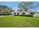 Well-maintained front yard with lush green lawn, manicured hedges, and a charming home exterior at 4335 S Coolidge Ave, Tampa, FL 33611