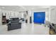 Open concept living room with modern decor and striking blue double doors at 4335 S Coolidge Ave, Tampa, FL 33611